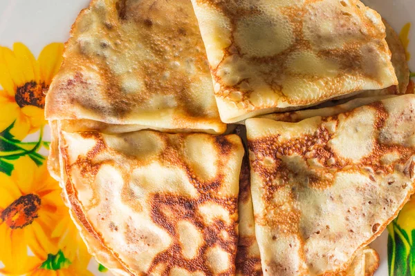 Appetizing folded in triangles pancakes on a plate — Stock Photo, Image