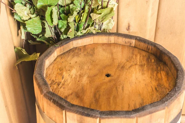 Wooden pail with birch broom in the sauna — Stock Photo, Image