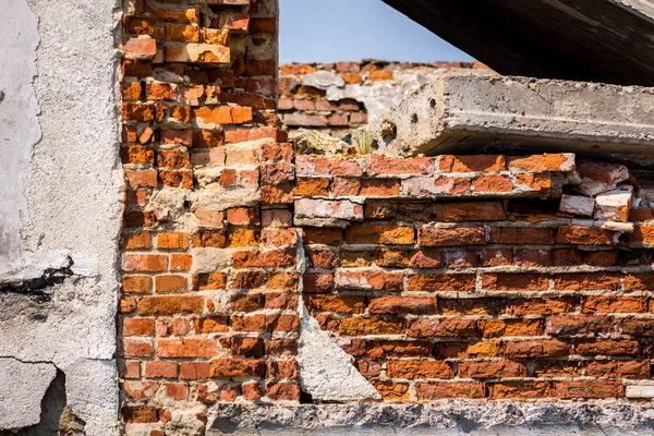 The collapsed red brick building.