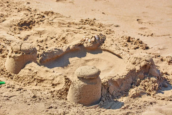 Sand castle made by childrens bucket on beach. — Stock Photo, Image