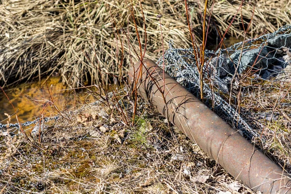 Rusty pipe for water drainage.