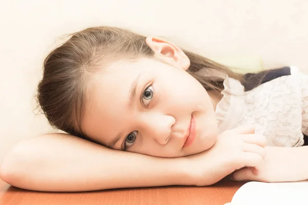 Tired schoolgirl is on the table — Stock Photo, Image