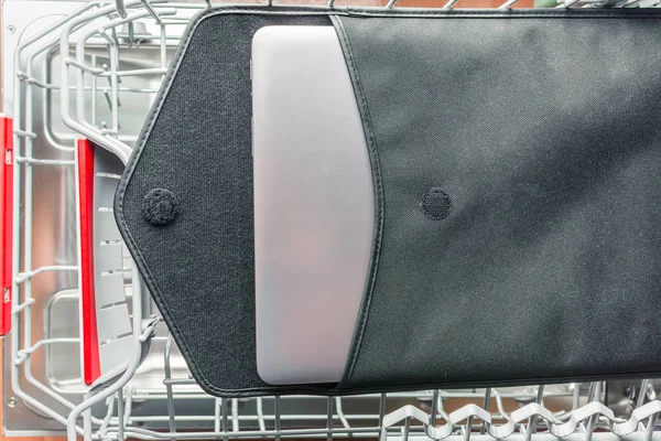 Laptop in a black case lies in the dishwasher — Stock Photo, Image