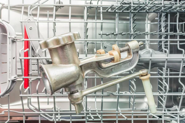 Hand grinder lies on the washing shelf in the dishwasher — Stock Photo, Image