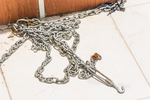 Long iron chain on tile for fastening.