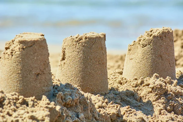 Sand castle made by childrens bucket on beach. — Stock Photo, Image