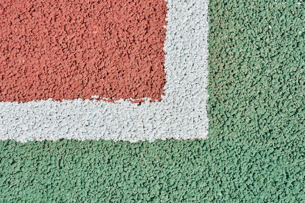 Corner markings on red tennis court for game