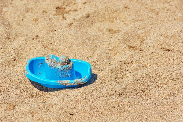 Kinderspielzeugboot am Sandstrand. — Stockfoto