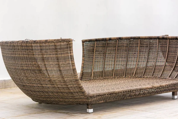 Wicker sofa without pillows for rest.