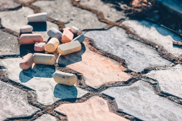 Set of colored crayons for drawing on the painted road from tile. — Stock Photo, Image