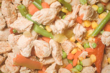 Tavada sebze karışımlı kızarmış tavuk parçaları..