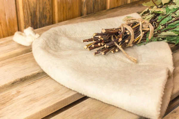 Birch broom lies on a white hat in a bath — Stock Image Birch broom lies on a white hat in a bath Royalty Free Stock Images