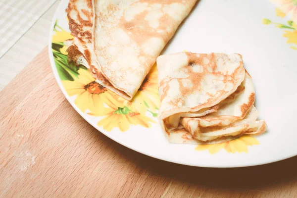Panqueques amarillos para el desayuno en plato grande sobre tabla de madera . — Foto de Stock