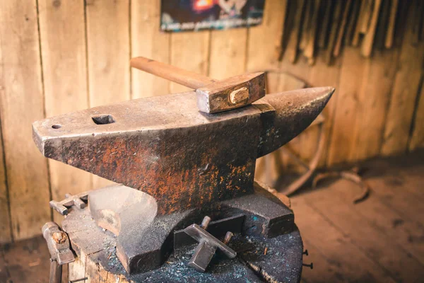 Iron anvil with blacksmith\'s hammer for the manufacture of metal products