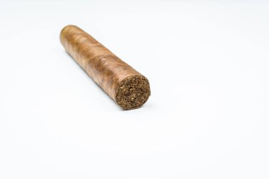 Beyaz arka planda bükülmüş çarşaflardan çıkan Küba purosu