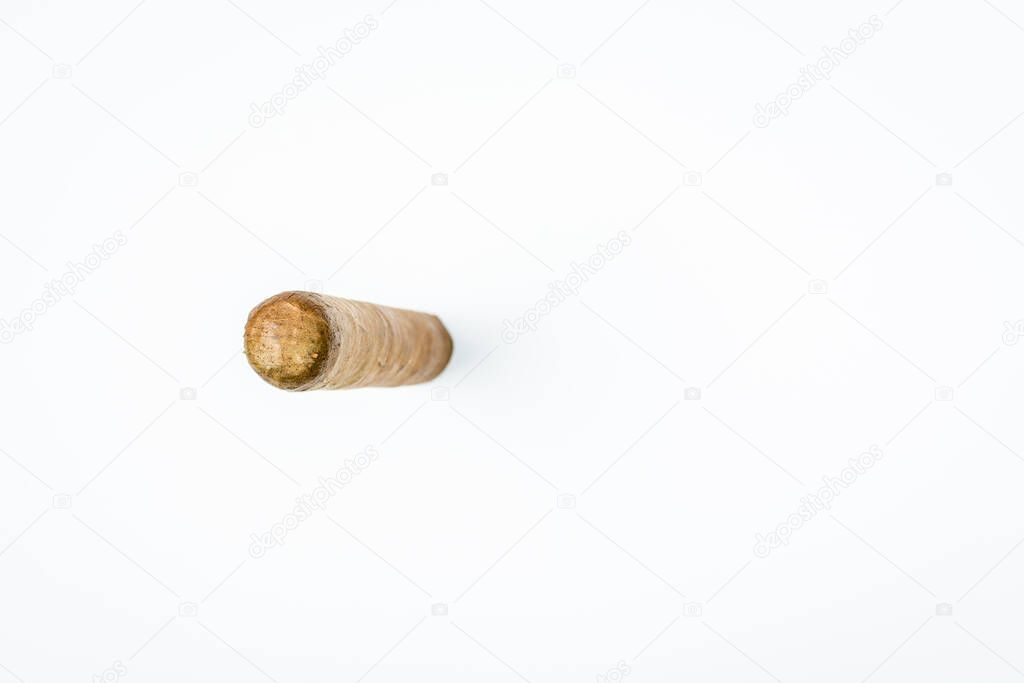 Long thick cigar from twisted sheets on white background