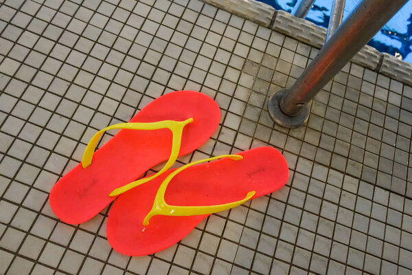 STOCKHOLM SWEDEN Poolside flipflops at a grimy municipal pool.