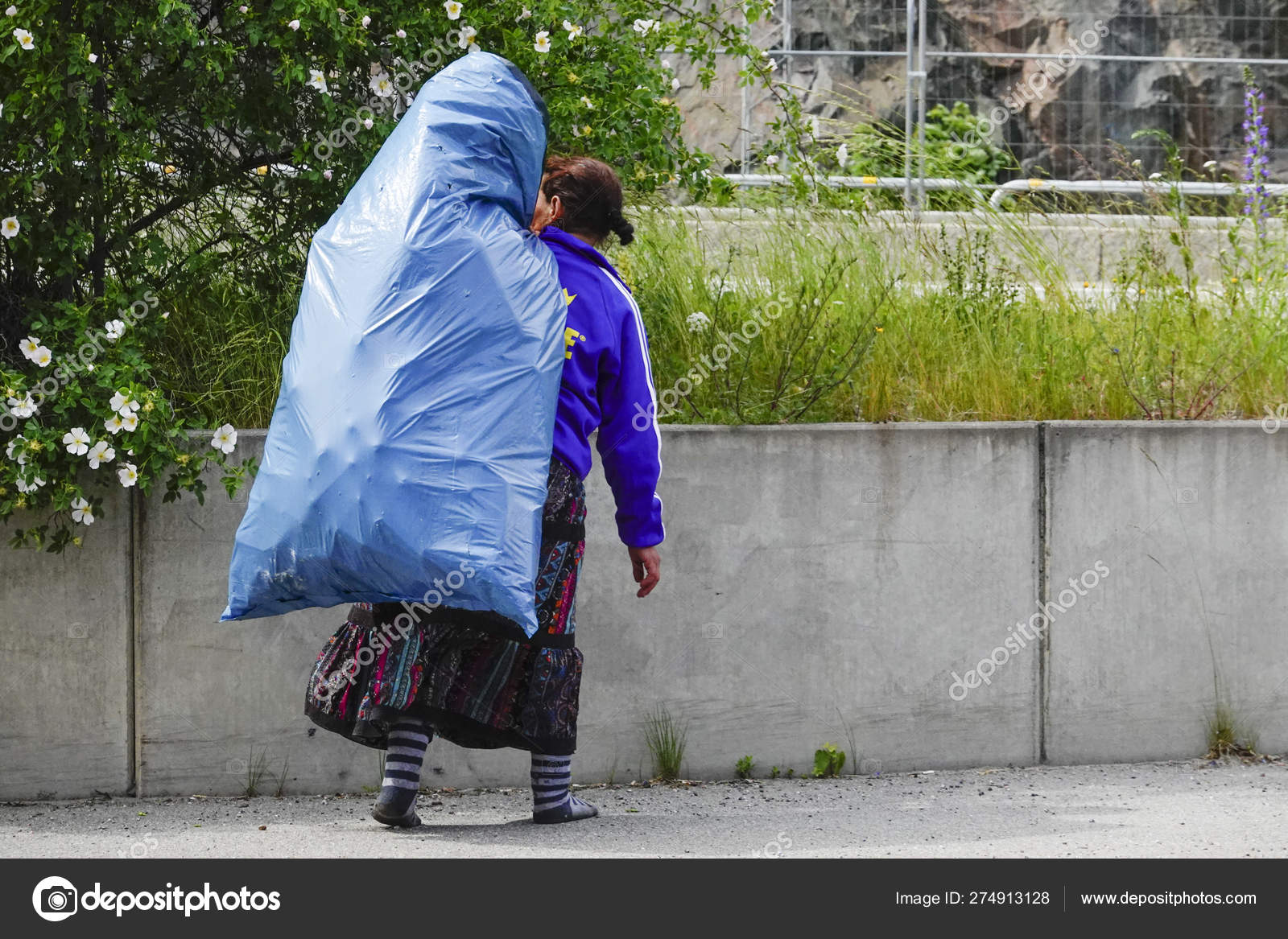 瑞典斯德哥尔摩一个罗马尼亚乞丐在公路边提着一袋可兑换的罐子—— 库存社论照片© Alexander2323 #274913128