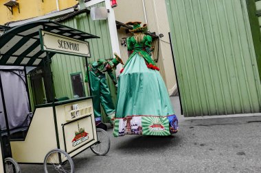 Stockholm, Sweden Stilt-walkers or performers prepare their outfits to perform at the Grona Lund amusement park. clipart