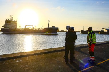 Hirtshals, Danimarka Liman işçileri demirleme hatları beklerken limana sabahın erken saatlerinde bir tanker geldi.