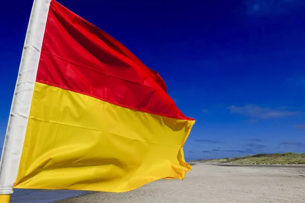 Hirtshals, Denmark Red and yellow flags mean Lifeguards are on patrol. You should only swim or boogie board in the area between the flags. The red flag means it is dangerous to bathe or swim and you should not go into the water.