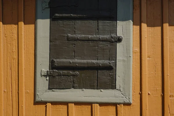 Stockholm, Sweden A detail of a shuttered window on an old Swedish cabin on Beckholmen.