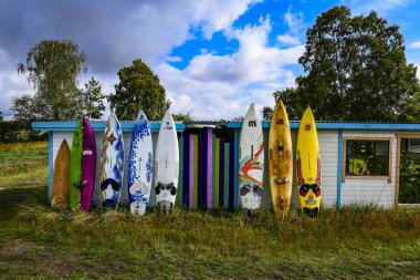 Visby, Gotland, Sweden Surfboards lined up at a beach. clipart