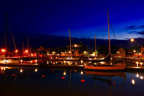 Visby, Gotland, Sweden The port of Visby at night with sailboats.
