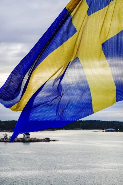 Turku, Finland, A Swedish flag flies over the stern of a ferry boat.