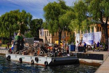 Stockholm, Sweden  Trash pulled up from the bottom of Lake Malaren and displayed on a barge, a community project called Rena Malaren. clipart