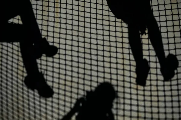 Klitmoller, Denmark People hanging out a the beach and shadows projected on a wall.