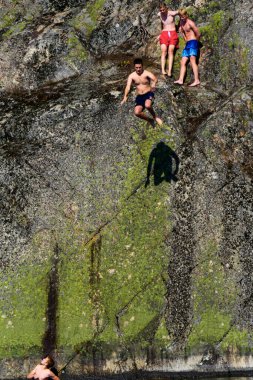 Stockholm, Sweden  Teenagers jumping into Lake Malaren from a cliff.