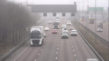 Stockholm, İsveç E4 karayolunda güneye giden trafik sisli bir günde.  