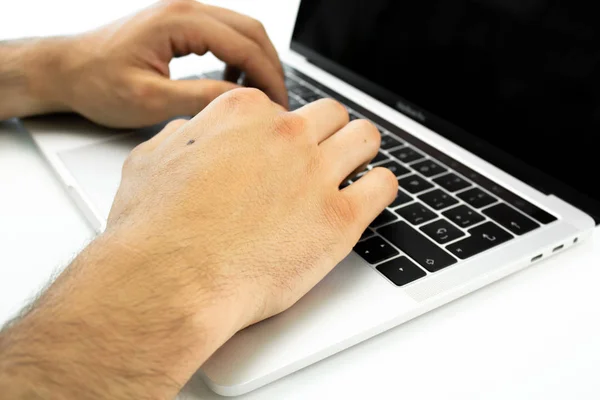 Business person using the keyboard of a laptop on a white table. Person working. — Stock Photo, Image