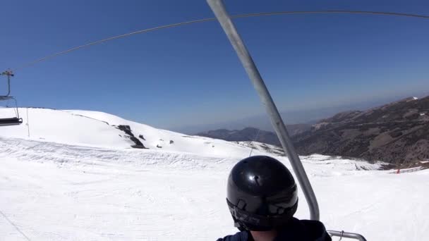 Snowboarder Sitting Chairlift Cable Car Going Snowy Mountain Ski Resort — Stock Video