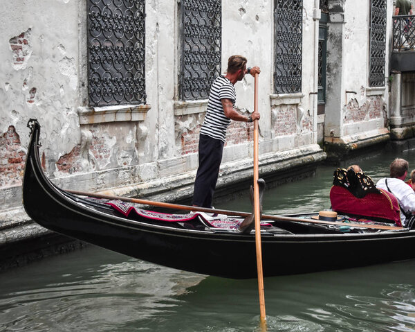 Gondolier and his gondola, a typical scene in Venice.