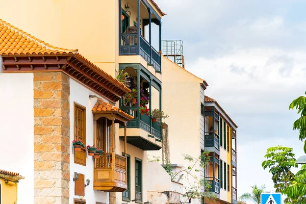 Kleurrijke gebouwen met houten balkons aan een straat in Puerto de la Cruz op een zonnige dag, Tenerife, Canarische eilanden, Spanje. — Stockfoto