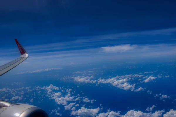 This unique image shows the Maldives photographed on a plane from above. you can see the sky and the clouds from the airplane