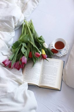 lale buketi, bir kitap ve çay