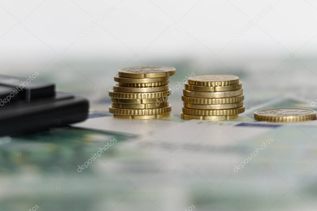 Euro banknotes with a calculator and coins. Close-up. Business concept