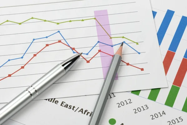 Business goal concept. Business accessory, graph charts and pencil on the table.