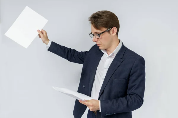 Businessman with scattered papers. Business, people, emotions - businessman throws documents in the office. Business and finance concept.