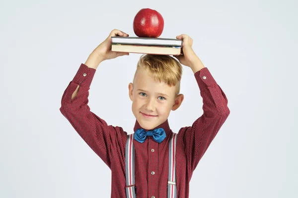 Colegial Sostiene Libros Con Una Manzana Cabeza Sonríe Fondo Aislado — Foto de Stock