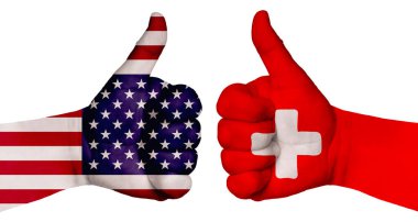 Ulusların ilişkilerini güçlendirme kavramı. İki el farklı ülkelerin bayraklarıyla boyanır ve başparmak kaldırılır. İsviçre ve ABD