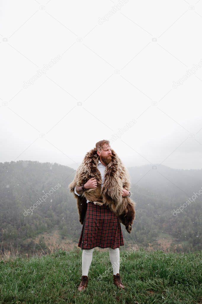 man with mustache beard bear with a tattoo is standing mountain caucasian
