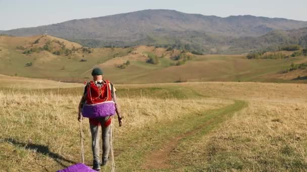 Muž vousatý knírek nosí padák na pozadí hor — Stock video