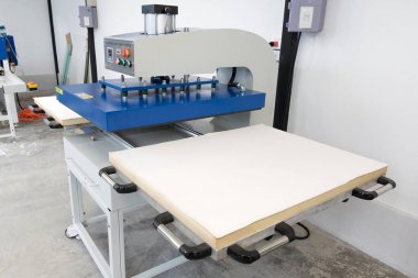 Pathumthani, Thailand - Feb 27, 2017 : Large heat press machine for fabric business in printing factory at Lumlukka, pathumthani Thailand. Editorial Used Only. clipart