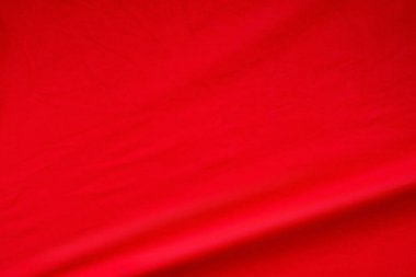 Kırmızı kumaş arka plan. Zarif canlı ipek dalga malzeme dokusu.