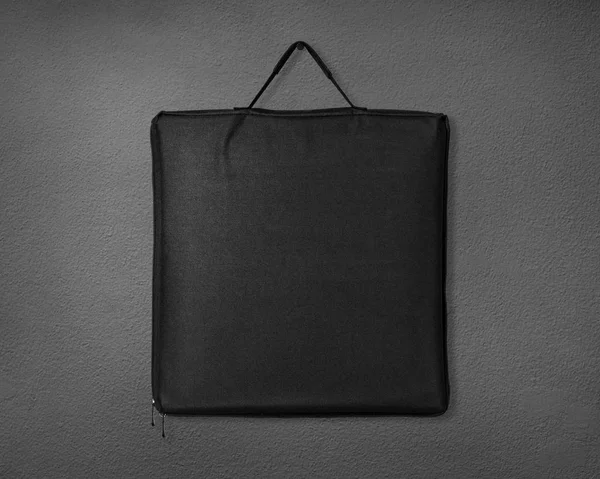 Black fabric bag on cement background. Shopping canvas bag for design.