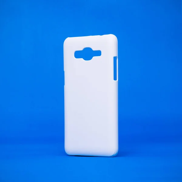Mobile cases on vivid blue backdrops. Phone cover for your design. Smartphone accessory or trendy fashion.